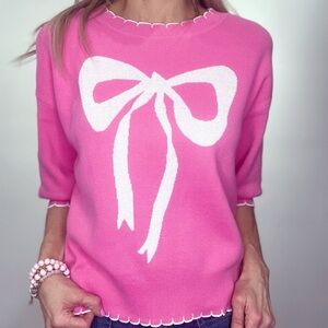 Pink Sweater with White Bow Design